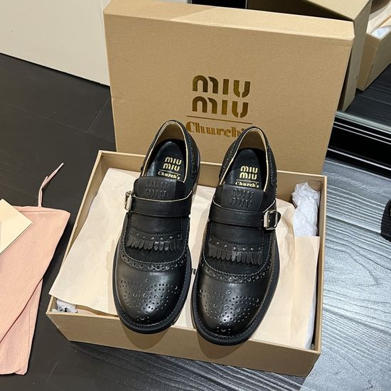 Miu Miu Elegant Tassel Loafers with Baroque Carving