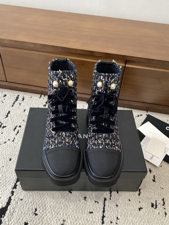 Chanel Elevated Leather Ankle Boots with Classic Fabric and Pearl Buttons