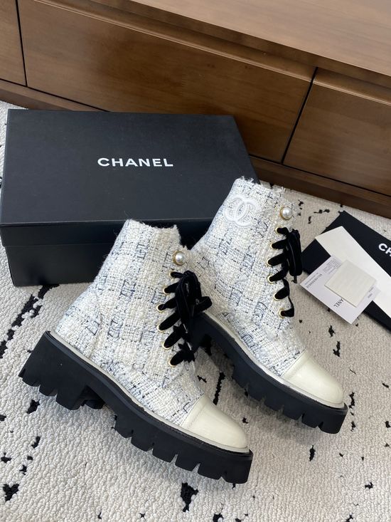 Chanel Elevated Leather Ankle Boots with Classic Fabric and Pearl Buttons