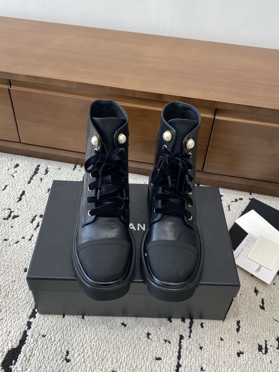 Chanel Elevated Leather Ankle Boots with Classic Fabric and Pearl Buttons