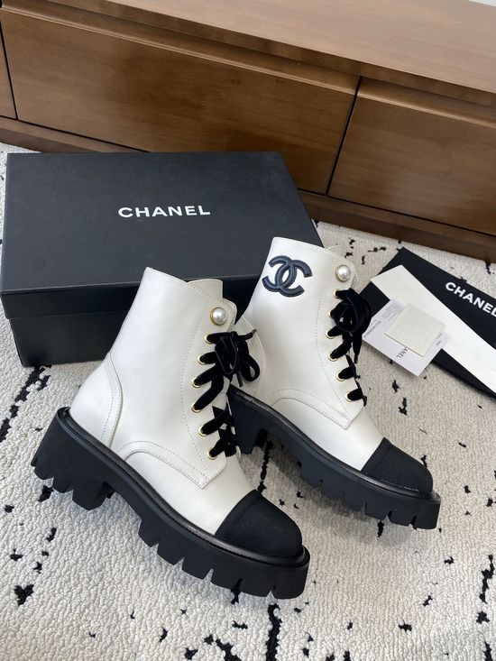 Chanel Elevated Leather Ankle Boots with Classic Fabric and Pearl Buttons