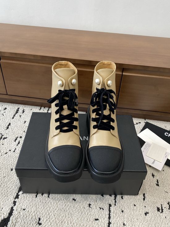 Chanel Elevated Leather Ankle Boots with Classic Fabric and Pearl Buttons